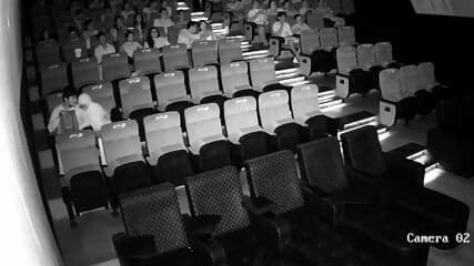 A couple having sex in front of everyone in a cinema hall